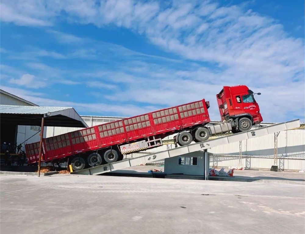 液壓卸車機、后翻式液壓翻板卸車平臺、河南愛信液壓翻板機